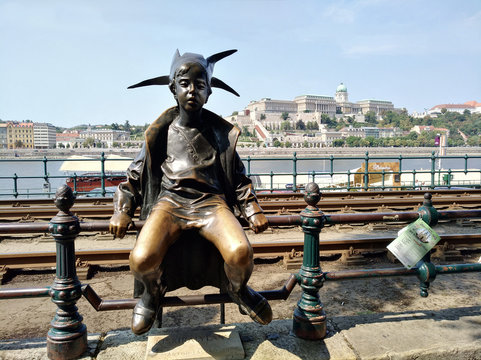Budapest, Hungary - 5 august 2018:Little Princess (Kiskiralylany) bronze statue created by Laszlo Marton located on the Danube rive