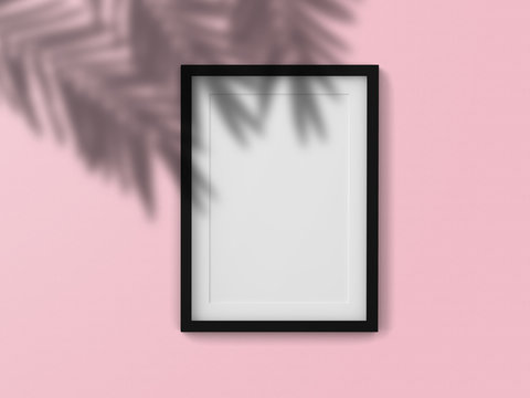 Mockup blank photo frame with shadow leaf on the wall.