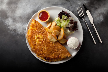 omelet with potato sauce and salad