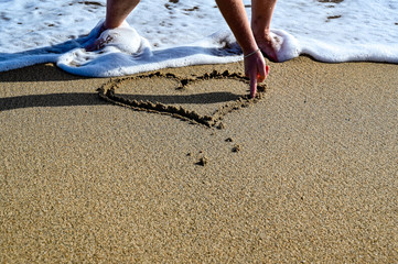 hart made by hand on a sand beach