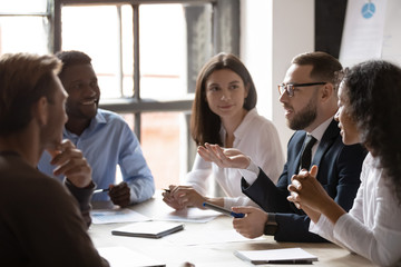Multiracial business team people listening male mentor at marketing workshop