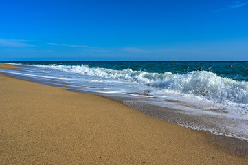 Fototapeta na wymiar sandy beach and waves in Mediterranean sea