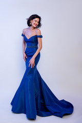 Fototapeta premium fashionable woman in a blue dress on the floor. 