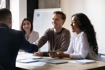 Fototapeta premium Happy hr employer handshake male applicant partner at interview meeting