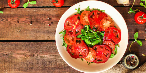 healthy salad tomatoes (vegetables, onions, greens, lettuce, sunflowers, microgreens and more) menu concept. food background. copy space. Top view