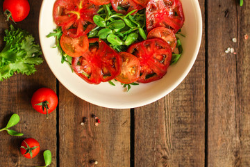 healthy salad tomatoes (vegetables, onions, greens, lettuce, sunflowers, microgreens and more) menu concept. food background. copy space. Top view