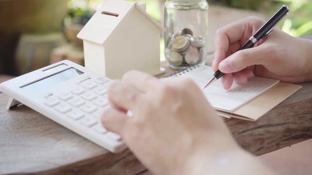 Slow motion Asian male hands Calculate with a calculator Home incomes and expenses and savings, investment concepts, savings