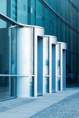 Modern glass building with revolving door in the city