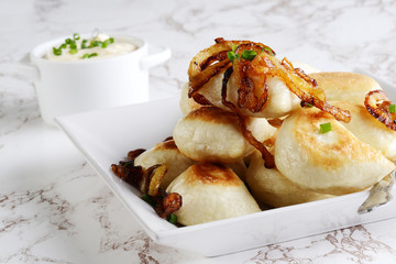 pierogies with caramelized onions on a plate