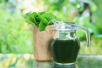 Gotu kola , Asiatic pennywort, Indian pennywort  juice in jar with green blur background.