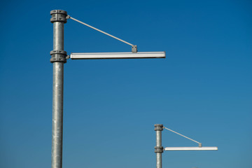 Modern street lamps in the city. Blue sky.