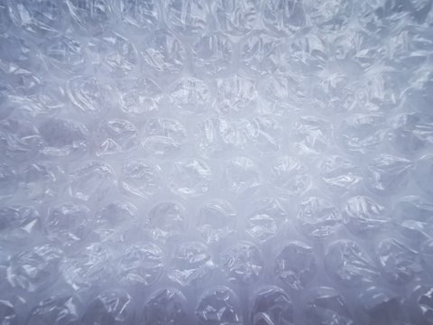 Bubble wrap. Plastic packaging material. Close-up photo. Free antistress. Abstract light background