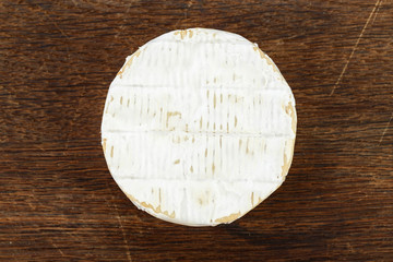 brie cheese on wooden background