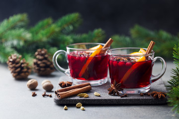 Mulled red wine with spices. Christmas decoration. Grey background. Copy space.