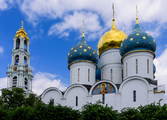 Fototapeta na wymiar The dome of the Orthodox Cathedral against the blue sky. The Holy Trinity - St. Sergius Lavra in Sergiev Posad near Moscow, Russia, tourist attraction as a part of the Golden Ring of Russia.