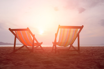 Two canvas chairs on the beach background at sunset in summer at Sai Kaew Beach, Thailand