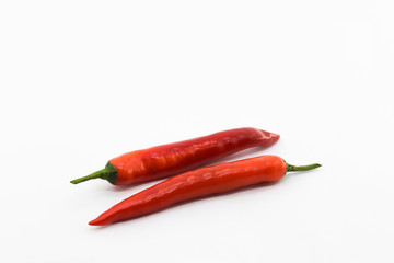 Two red chili pepper on white background