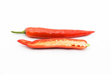 Whole chili and half sliced red chili pepper on white back ground