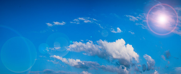 blue sky with clouds and sun