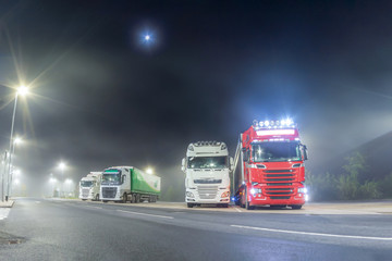 Truck stop at night in the mist