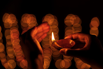 Indian Woman Celebrating Diwali Festival. Indian girl or woman holding or protecting traditional...