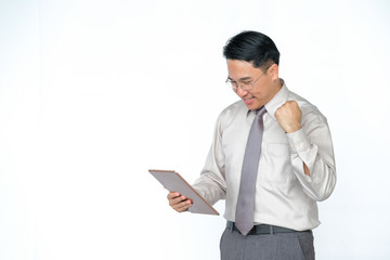 Happy middle-aged Asian men using tablets on a white background