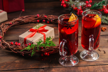 Naklejka na ściany i meble Christmas mulled wine on a wooden table. Traditional hot drink at Christmas (red wine with spices, New Year's Eve, Noel holiday festive) x-mas flat lay. food background. copy space. Top viev