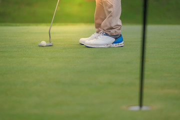 Playing golf preparing to shot man putting on green