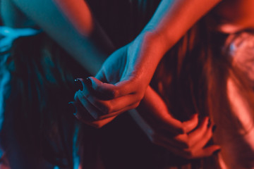 Close up on female young woman's girl's beautiful hands woman lying on the bed with black nail...