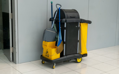 closeup of janitorial. yellow mop bucket and set of cleaning equipment at the airport.