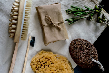 eco natural bamboo toothbrushes in glass on rustic background with greenery. sustainable lifestyle concept. zero waste home. bathroom essentials, plastic free items