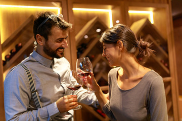 Happy couple taste wine in the restaurant