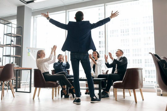 business people congratulating their parter with successful deal which he has done, back view photo. good job, well done. panorama window in the background of the photo