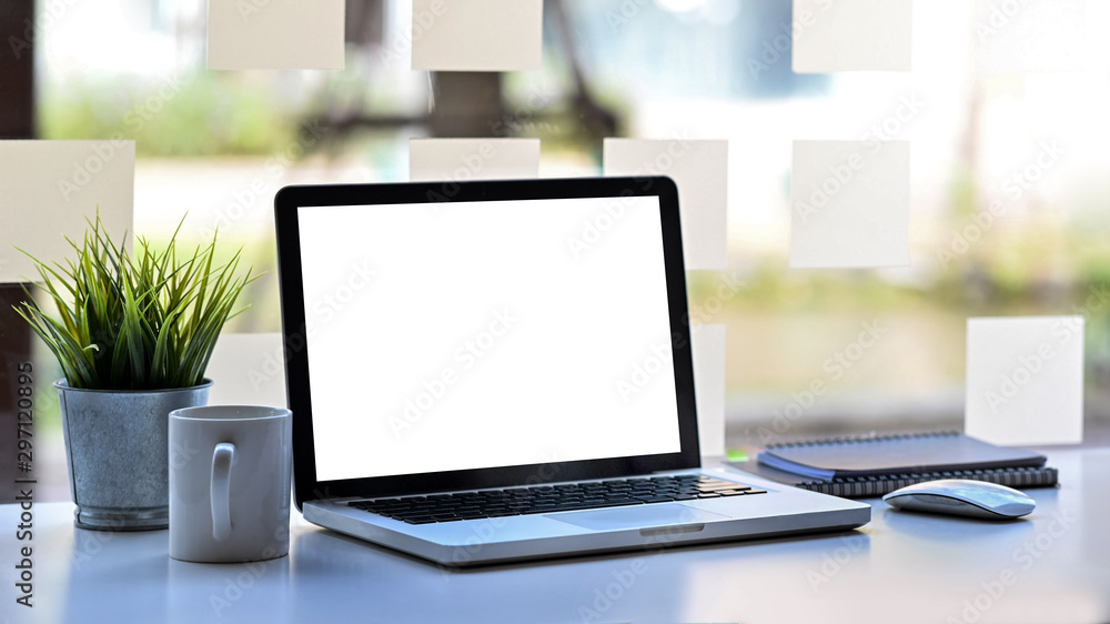 Poster laptop computer with empty screen on workspace office table.
