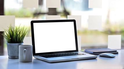Fototapeta premium Laptop computer with empty screen on workspace office table.