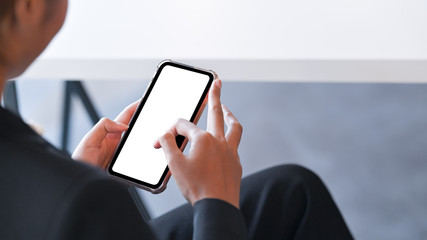 Cropped shot young businesswoman touching mockup smartphone.