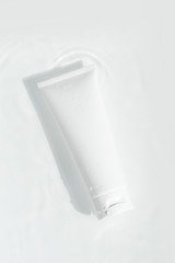 fresh beauty spa medical skincare and cosmetic lotion cream facial tube bottle packaging product on white decor background with summer season sun light