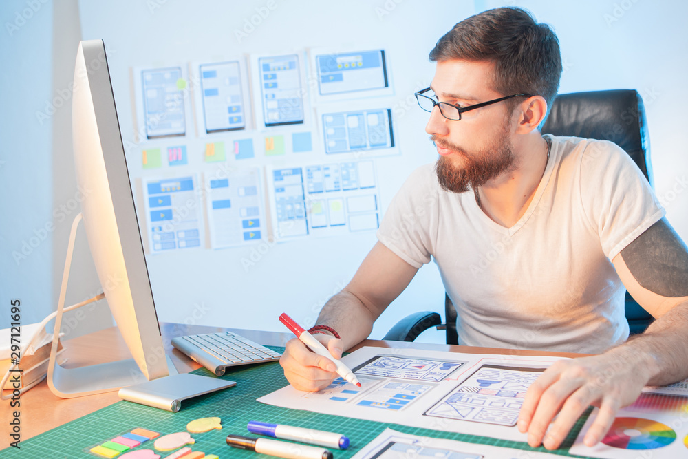Poster the designer develops the scheme of the mobile application. the man fills in the dialog box template
