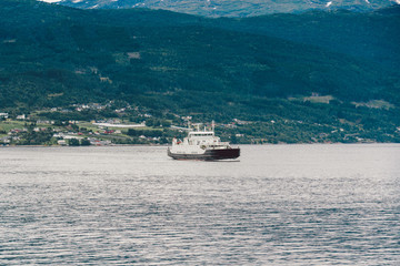 Ferry boat transportation Norway. White passenger ferry goes on fjord. In Norway. ferry crossing a fjord. Ferryboat cruising on Norwegian fjord