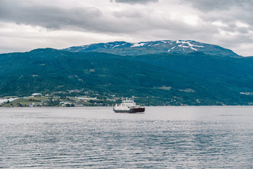 Ferry boat transportation Norway. White passenger ferry goes on fjord. In Norway. ferry crossing a fjord. Ferryboat cruising on Norwegian fjord