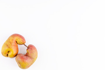Ugly fruits - organic ripe pears on white background. Concept of zero waste production in food industry and a world without starvation. Copy space. Top view.