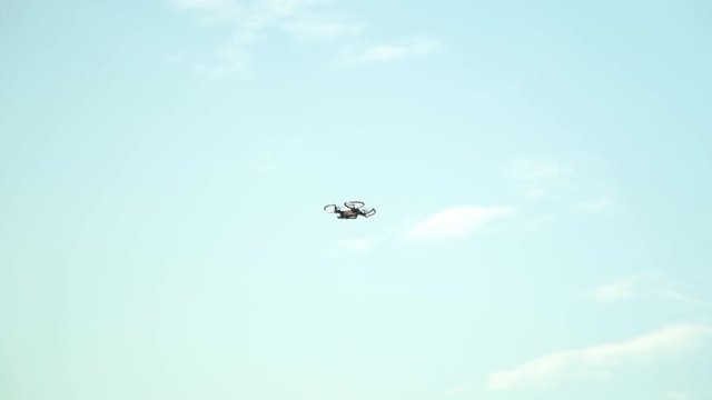 drone flying in the morning , Flying and filming with drone camera. Quadcopter hovers in the air.