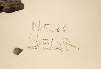 New Year written on sandy beach. Tropical celebration. New Year's tour