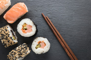Sushi pieces on top and wooden chinese chopsticks top view