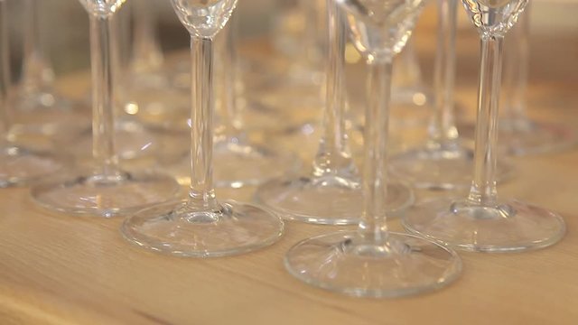 Empty glass goblets on a bar counter. Rows of empty goblets for wine or champagne on a high leg. Restaurant Bar Concept