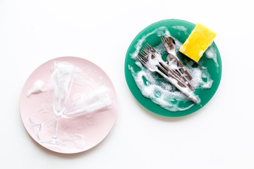 Washing dishes concept. Plates, spoons, forks on white background top view