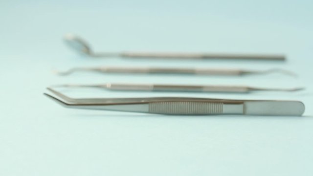 Dentist choose or rearrange set of dentist tools on blue background: Dental Hygiene and Health conceptual image