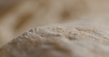 Extreme closeup of cutting ciabatta bread