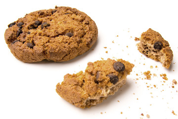 Sweet cookies with raisins isolated on a white background. Whole cookies and pieces and crumbs of cookies.