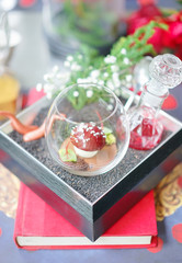 Fairy tales dessert with red mushroom made from chocolate cherries and kirsch. Inside the glass bottle is raspberry sauce. fairytale and bedtime story concept.